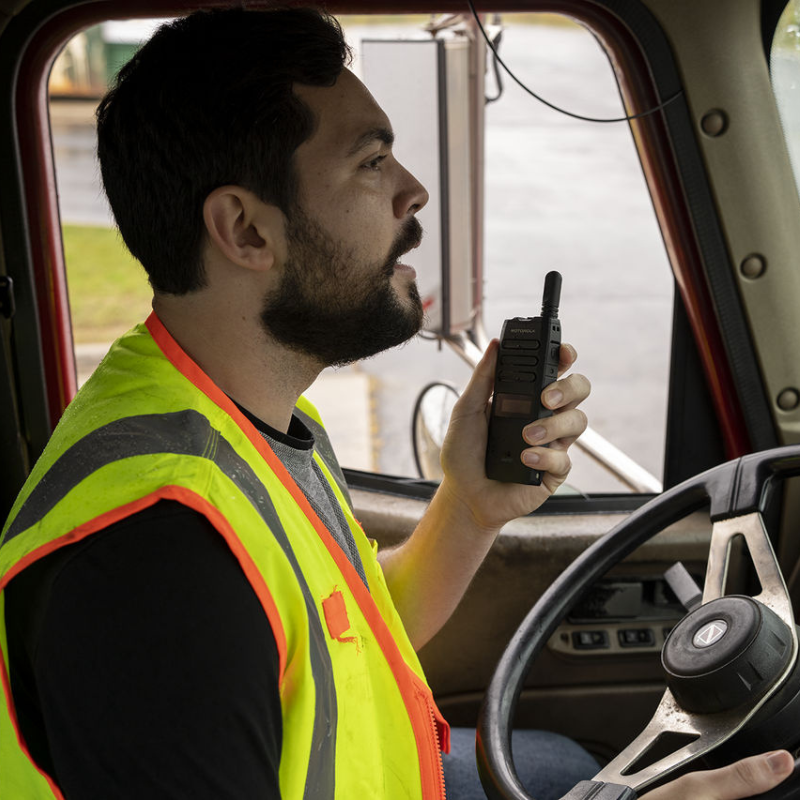 Truck driver using the Motorola TLK110 Poc radio